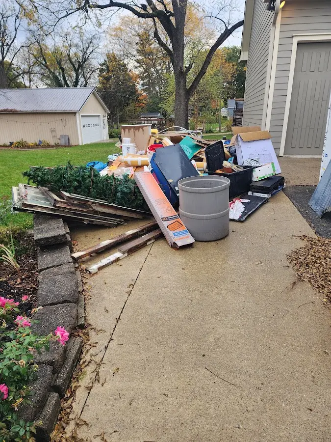 Dumpster being loaded with debris for Residential Dumpster Rental in Windham